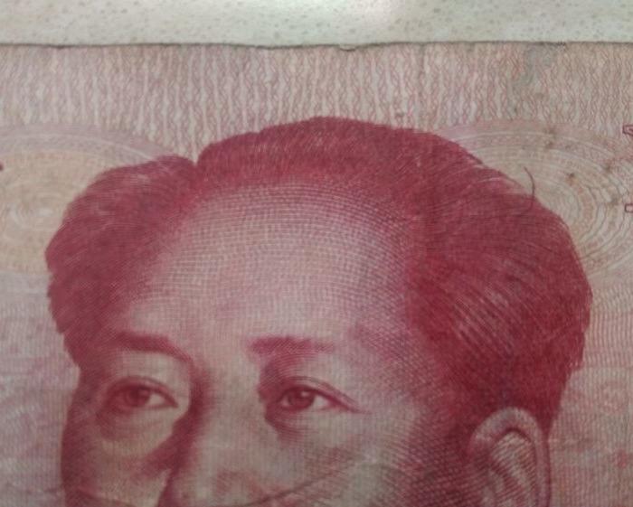 100元人民币上。毛主席头像上有一根头发特别