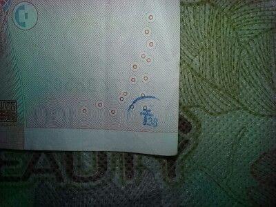 刚收到这张人民币有蓝色标志是什么意思?_刚